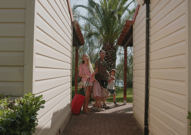 Famiglia in vacanza tra bungalow e palme.